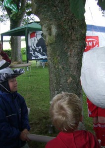 Kids hitting the alarm clock piñata.