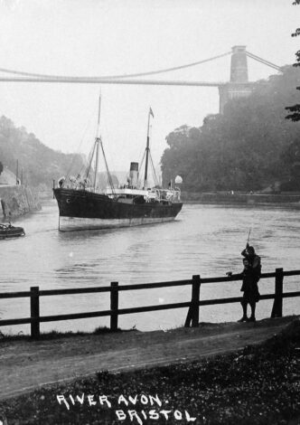 A steamer with a steam tug under Clifton Suspension Bridge.