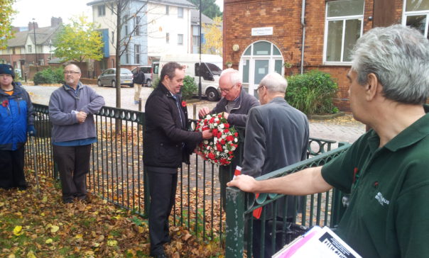 David Jeffries and members of the Remembering the Real WWI Group attaching the wreath to the railings at Dings Park.