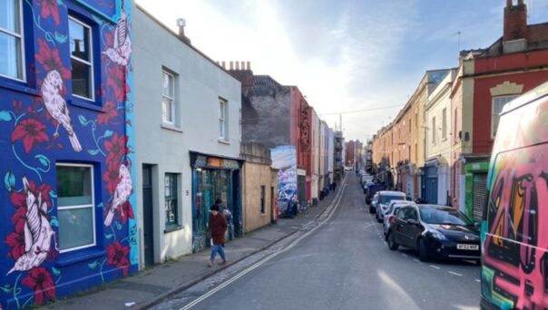 Picton Street in Montpelier, 2023 with colourful buildings and parked cars.